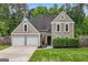 Charming two-story home featuring a well-manicured lawn and a two-car garage at 150 Rockspray Rdg, Peachtree City, GA 30269