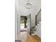 Bright foyer showcasing a hardwood floor, elegant lighting, and a staircase at 150 Rockspray Rdg, Peachtree City, GA 30269