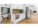 View of kitchen cabinets and stainless steel refrigerator, with a view to dining and living spaces at 150 Rockspray Rdg, Peachtree City, GA 30269