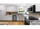 A close-up shot of the updated kitchen with granite countertops, stainless appliances, and lots of natural light at 150 Rockspray Rdg, Peachtree City, GA 30269