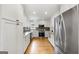 Beautiful kitchen with stainless appliances, gorgeous granite counters, and white cabinetry and hardware at 150 Rockspray Rdg, Peachtree City, GA 30269