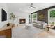 Well-lit living room with a fireplace, flat-screen TV, a comfy couch and a wood accent wall at 150 Rockspray Rdg, Peachtree City, GA 30269