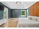 Serene main bedroom boasts natural light, wood floors, and a tray ceiling at 150 Rockspray Rdg, Peachtree City, GA 30269