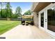 Covered patio with an outdoor dining set, lounge furniture, and landscaped surroundings at 150 Rockspray Rdg, Peachtree City, GA 30269