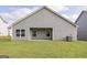 Rear view showcasing a spacious backyard, patio, and the home's exterior at 281 Limestone Circle, Conyers, GA 30013