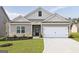Charming home featuring a two-car garage, tasteful brick accents, and a well-manicured lawn at 281 Limestone Circle, Conyers, GA 30013