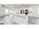 Open-concept kitchen featuring granite countertops, stainless steel appliances, and modern white cabinets at 281 Limestone Circle, Conyers, GA 30013