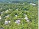 Aerial view highlighting a stunning home with a pool surrounded by mature trees and beautiful landscapes at 602 Embassy Ct, Peachtree City, GA 30269