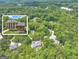 Aerial view of a grand estate surrounded by lush greenery, showcasing its expansive grounds and location at 602 Embassy Ct, Peachtree City, GA 30269
