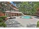 Backyard with lawn, pool, outdoor furniture and a large red brick home at 602 Embassy Ct, Peachtree City, GA 30269