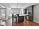 Basement wet bar features bar seating, a wine rack, sink, and modern lighting at 602 Embassy Ct, Peachtree City, GA 30269