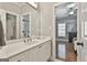 Bright bathroom with a white vanity, marble countertops, and a view into the bedroom at 602 Embassy Ct, Peachtree City, GA 30269