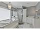 Bathroom featuring a large tub, and a walk-in shower with glass enclosure at 602 Embassy Ct, Peachtree City, GA 30269