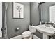 Chic powder room features a pedestal sink, modern fixtures, and stylish decor at 602 Embassy Ct, Peachtree City, GA 30269