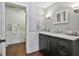 Elegant bathroom featuring a dark vanity with marble countertop, classic sconces, and a separate water closet at 602 Embassy Ct, Peachtree City, GA 30269