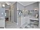 Elegant bathroom with double vanity, marble countertops, tiled floors, and a separate makeup vanity area at 602 Embassy Ct, Peachtree City, GA 30269