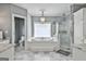 Bathroom featuring a large tub, and a walk-in shower with glass enclosure at 602 Embassy Ct, Peachtree City, GA 30269