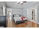 Bedroom with hardwood floors, a ceiling fan, and a door leading to an ensuite bathroom at 602 Embassy Ct, Peachtree City, GA 30269