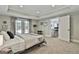 Cozy bedroom featuring soft carpet, tray ceiling, and double doors leading outside for easy access to the backyard at 602 Embassy Ct, Peachtree City, GA 30269