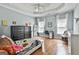 Bright bedroom featuring hardwood floors, a ceiling fan, two windows, and ample natural light at 602 Embassy Ct, Peachtree City, GA 30269