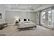 Spacious bedroom with a tray ceiling, neutral carpet, and French doors leading to a private outdoor space at 602 Embassy Ct, Peachtree City, GA 30269
