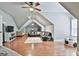 Spacious bonus room with hardwood floors, a large sectional sofa, and a TV area, ideal for entertainment at 602 Embassy Ct, Peachtree City, GA 30269