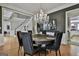 An elegant dining room features hardwood floors, a staircase, and a sparkling chandelier at 602 Embassy Ct, Peachtree City, GA 30269