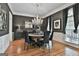 Elegant dining room with a decorative chandelier, dark walls, and a round wooden table for a sophisticated ambiance at 602 Embassy Ct, Peachtree City, GA 30269