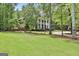 A charming brick home with white columns and a well-maintained front lawn at 602 Embassy Ct, Peachtree City, GA 30269