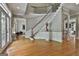 Grand foyer with hardwood floors, a curved staircase, and stylish architectural details for an impressive entrance at 602 Embassy Ct, Peachtree City, GA 30269
