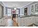 Open concept kitchen features stainless steel appliances, white cabinetry, granite countertops, and a breakfast nook at 602 Embassy Ct, Peachtree City, GA 30269