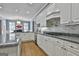Open kitchen features stainless steel appliances, granite countertops, a kitchen island, and tile backsplash at 602 Embassy Ct, Peachtree City, GA 30269