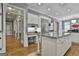 Bright kitchen features white cabinets, granite countertops, stainless steel appliances, and a desk area at 602 Embassy Ct, Peachtree City, GA 30269