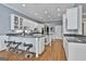 Spacious kitchen with granite countertops, stainless steel appliances, seating area, and white cabinetry at 602 Embassy Ct, Peachtree City, GA 30269