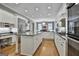 Spacious kitchen with white cabinets, granite countertops, and stainless steel appliances, perfect for cooking and entertaining at 602 Embassy Ct, Peachtree City, GA 30269
