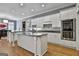 Modern kitchen features an island, stainless steel appliances, granite countertops, and white cabinetry at 602 Embassy Ct, Peachtree City, GA 30269