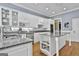 Bright kitchen with an island, granite countertops, stainless steel appliances, and white cabinetry at 602 Embassy Ct, Peachtree City, GA 30269