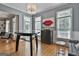 An open dining area features modern decor, a stylish light fixture, and large windows at 602 Embassy Ct, Peachtree City, GA 30269