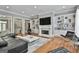 Spacious living room featuring built-in shelves, a fireplace, and modern furnishings for a comfortable living space at 602 Embassy Ct, Peachtree City, GA 30269