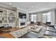 Spacious living room featuring built-in shelves, a fireplace, and modern furnishings for a comfortable living space at 602 Embassy Ct, Peachtree City, GA 30269