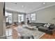 Spacious living room with hardwood floors, modern furniture, and ample natural light for a comfortable living space at 602 Embassy Ct, Peachtree City, GA 30269