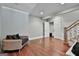 Hardwood floors featured in this living room with a sofa and staircase at 602 Embassy Ct, Peachtree City, GA 30269