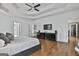 Spacious main bedroom with hardwood floors, a tray ceiling, and two dressers at 602 Embassy Ct, Peachtree City, GA 30269