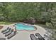 Overhead shot of a pool with lounge chairs and landscaping in a private backyard oasis at 602 Embassy Ct, Peachtree City, GA 30269