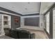 Finished theater room with a large screen, tiered seating and custom shelves at 602 Embassy Ct, Peachtree City, GA 30269
