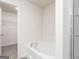 Clean, bright bathroom features a modern tub and access to a walk-in closet at 285 Limestone Circle, Conyers, GA 30013