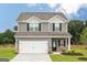 Charming two-story home with gray siding, white garage door, and manicured lawn at 285 Limestone Circle, Conyers, GA 30013