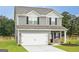 Charming two-story home with gray siding, white garage door, and manicured lawn at 285 Limestone Circle, Conyers, GA 30013