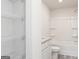 Bright bathroom featuring tub shower combo, wire shelving and granite countertops at 315 Limestone Circle, Conyers, GA 30013