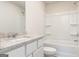 Bathroom featuring a granite countertop, white cabinets, and a shower-tub combo at 315 Limestone Circle, Conyers, GA 30013